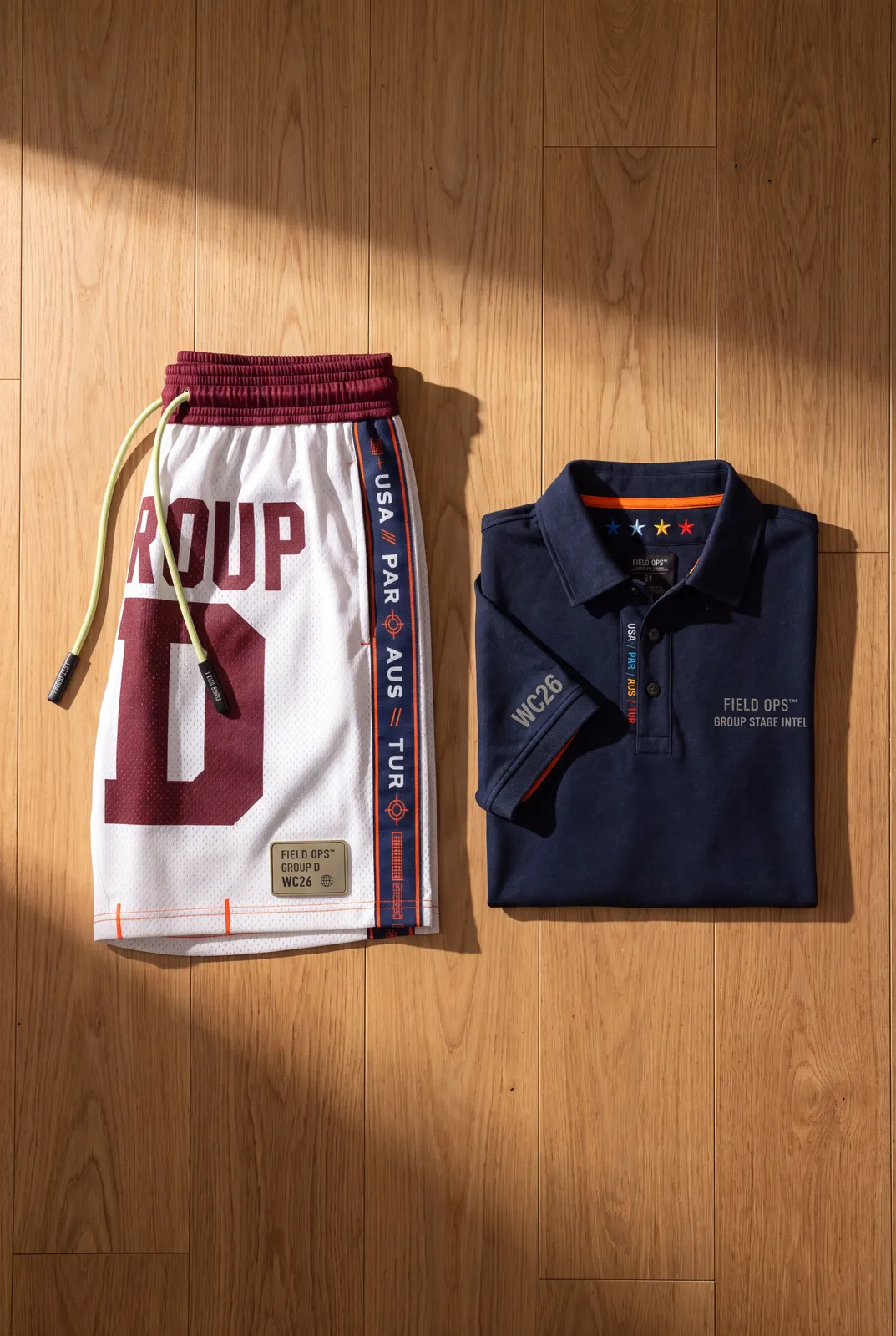 Group D polo and shorts flat lay.