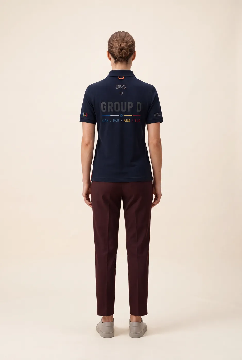 Group D polo worn on model, studio back.